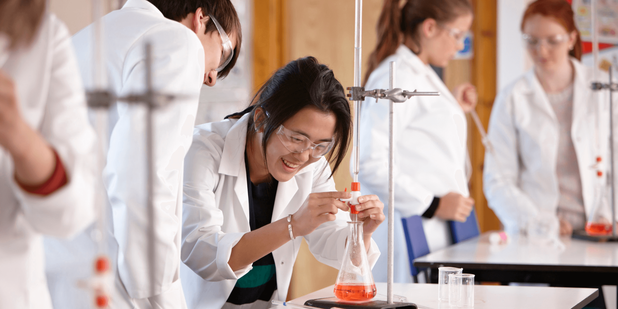Students in chemistry lab, titration experiment.