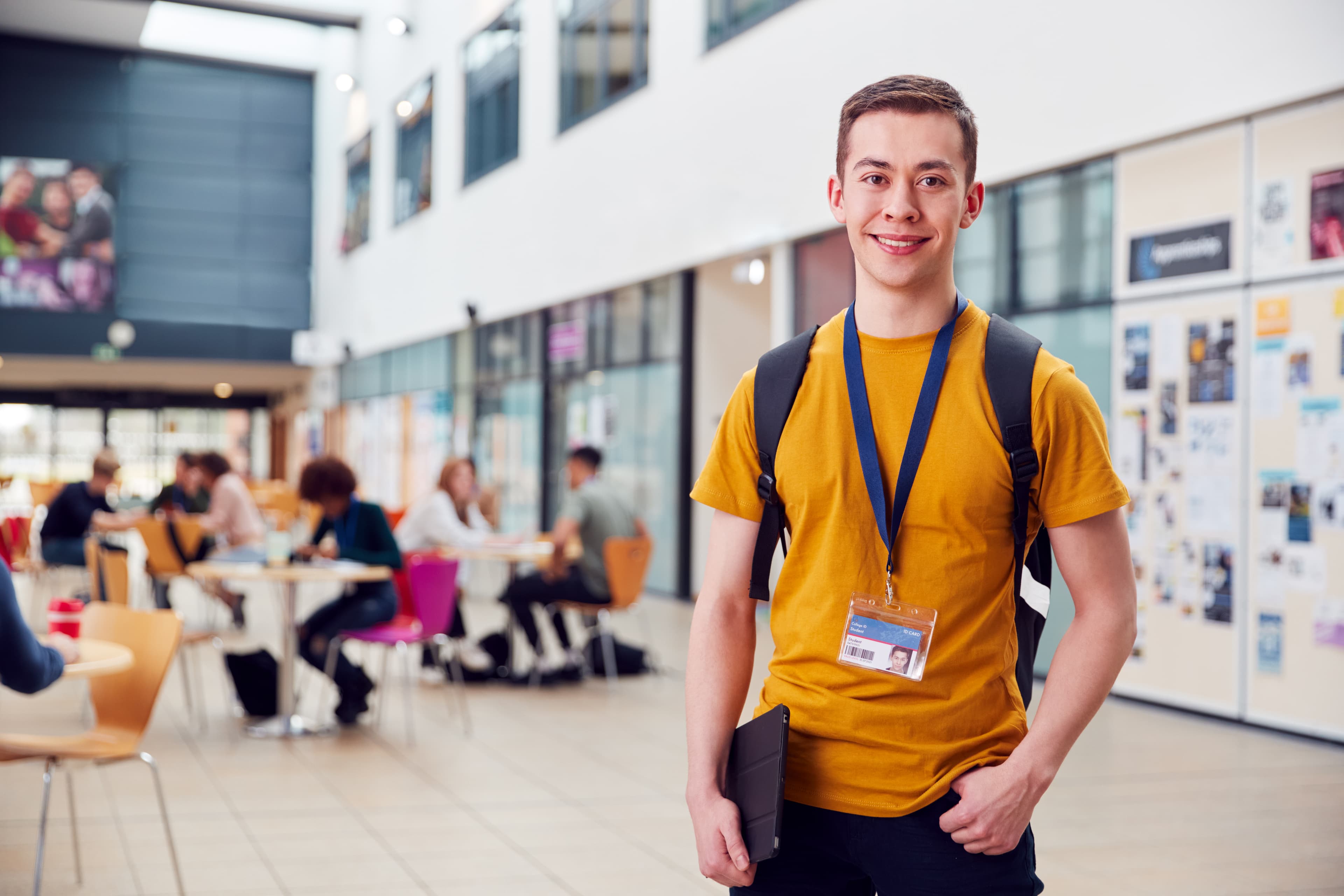 Student at sixth-form, wearing lanyard and smiling